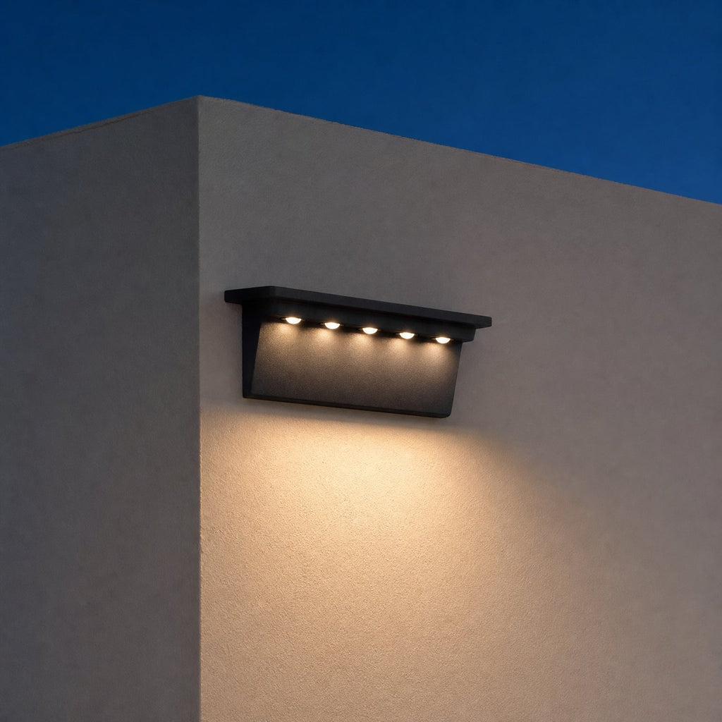 Solar Outdoor Wall Light, Weather-Resistant LED Fence & Porch Light mounted on an exterior wall at dusk, glowing warm white