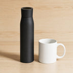 Self-Cleaning UV-C Water Bottle, Insulated Stainless Steel with Touch Display beside a coffee mug on a kitchen counter, showing its height