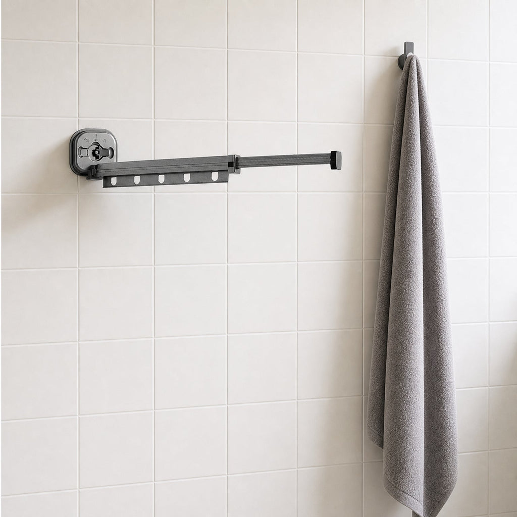 Suction Cup Drying Rack, No-Drill Telescopic Wall Rail for Laundry extended on a bathroom wall beside a hanging bath towel, for scale