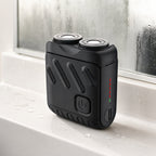 Rotary Electric Shaver for Men, Dual-Ring Blade Water-Resistant Grooming Razor, resting on a bathroom sink after use