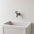 Wall Mounted Cold Water Tap, Solid Brass Single Faucet for Utility & Garden Sinks mounted above a compact utility sink, showing its size